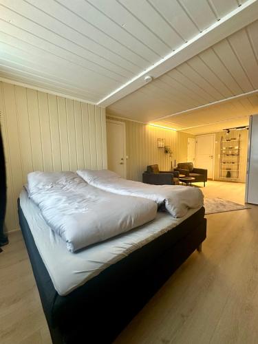 a bedroom with a large bed in a room at studio apartment with parking in Lillehammer