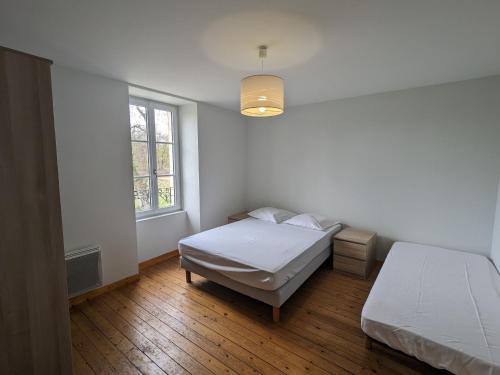a bedroom with two beds and a window at Maison de maître au cœur du Berry avec étang privé, grand jardin et vaste propriété - FR-1-591-116 in Migné