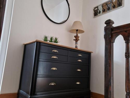 a black dresser with a mirror on a wall at Maison calme avec 3 chambres, proche centre-ville Lunéville & gare, accès facile à Nancy - FR-1-584-106 in Lunéville