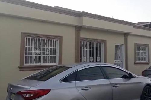 a silver car parked in front of a house at La Castillada House in Santa Cruz de Barahona