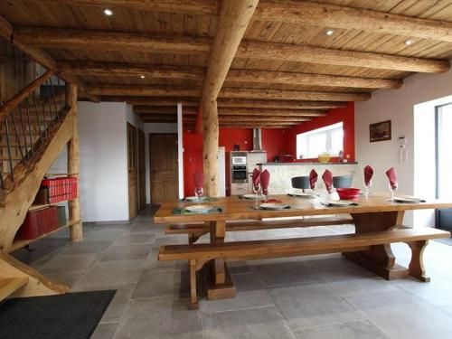 a large room with a wooden table and benches at Grand gîte cosy avec terrasse, jardin et jeux à Boisset, proche villages médiévaux et loisirs nature - FR-1-582-246 in Boisset