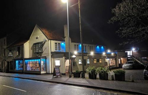 a building with blue lights on a street at night at The Tiger - formerly Cassia Rooms in Worksop