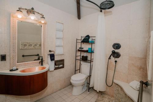 a bathroom with a tub and a toilet and a sink at Pantai Inn in San Diego