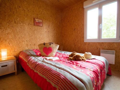 a bedroom with a bed with a teddy bear on it at Chalet Longeau-Percey, 3 pièces, 6 personnes - FR-1-611A-6 in Percey-le-Pautel