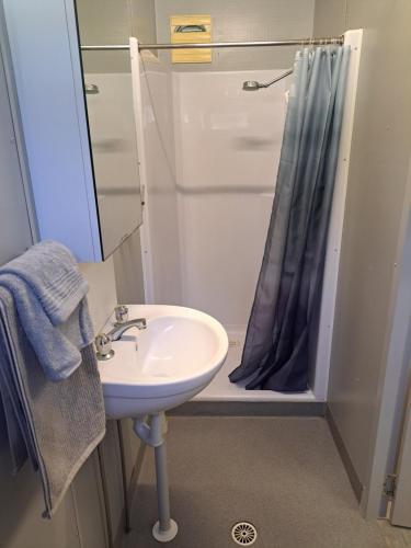 a bathroom with a sink and a shower at Cooktown Fishing Haven in Cooktown