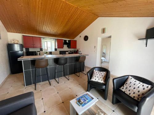 - une cuisine avec un bar et des chaises dans la chambre dans l'établissement Maison climatisée, 2 gîtes, 2 chambres, 15 hectares, loisirs, animaux acceptés - FR-1-426-520, à Bouin