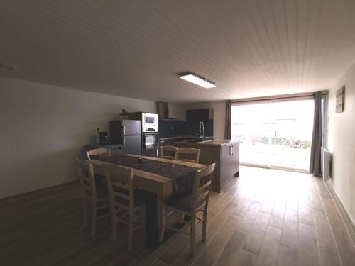 a kitchen with a table and chairs in a room at Maison de vacances rénovée à la ferme, terrasse, proche du Parc Ardes, Puy de Dôme et Brioude - FR-1-582-375 in Autrac