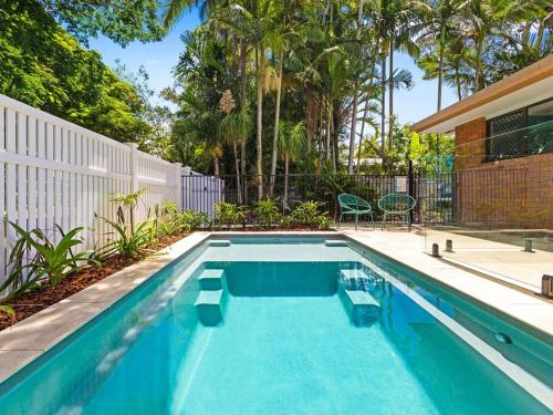 a swimming pool in the backyard of a house at Pet Friendly Spacious Home with Lush Gardens, Pool Sunshine coast in Pacific Paradise 