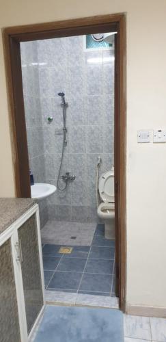 a bathroom with a shower and a toilet and a sink at HOUSE IN AL AIN - 3 in Al Ain