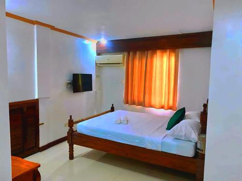 a bedroom with a bed and a window at Palawan Rose Garden 1 in Puerto Princesa City