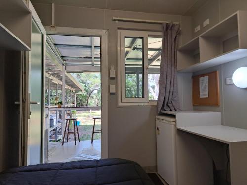 a small kitchen with a view of a yard at Cooktown Fishing Haven in Cooktown