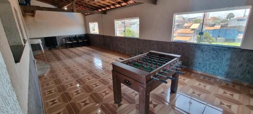 an empty room with a table in a room with windows at Casa com piscina e lazer em SBC SP in São Bernardo do Campo