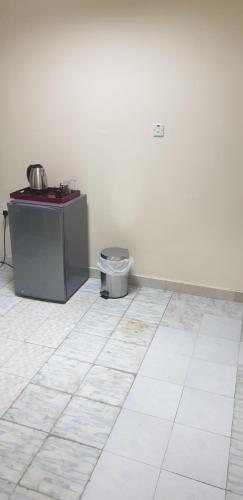 a bathroom with a toilet in the corner of a room at HOUSE IN AL AIN - 3 in Al Ain