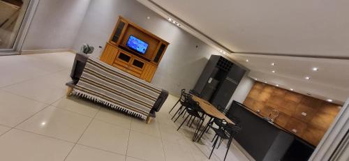 a room with a stage with chairs and a television at Casa en alquiler temporario Formosa in Formosa