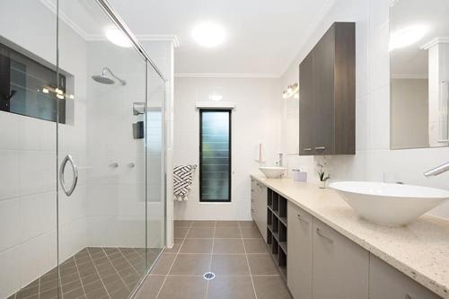 a white bathroom with a sink and a shower at Luxury Style Living 20 minutes from CBD 