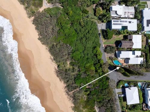 an aerial view of a beach with houses and the ocean at Four Pines Shelly Beach Retreat in Caloundra