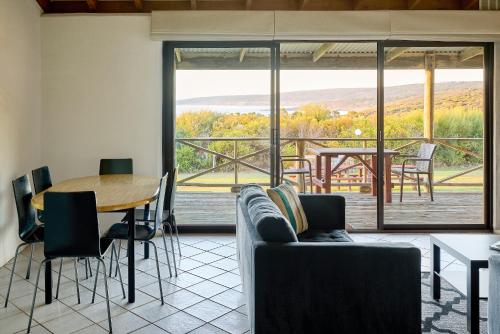 a living room with a couch and a table at Chandlers Smiths Beach Villas in Yallingup