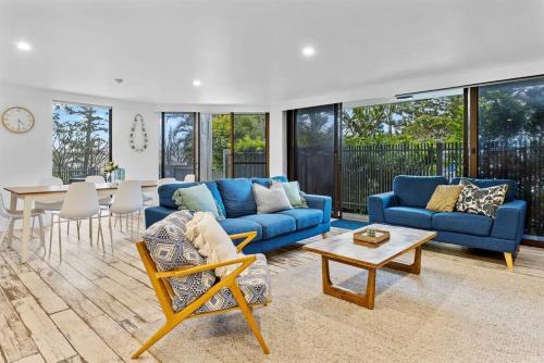 a living room with blue couches and a table at The Rocks Resort Unit GA in Gold Coast