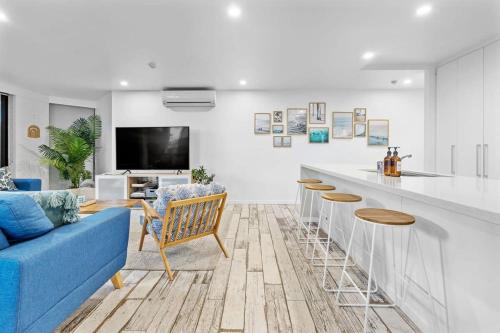 a living room with a blue couch and a counter at The Rocks Resort Unit GA in Gold Coast