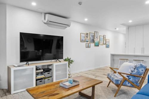 a living room with a tv and a couch and a table at The Rocks Resort Unit GA in Gold Coast