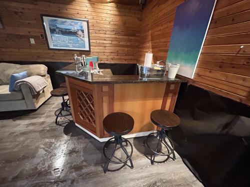 a bar in a room with stools in a cabin at Charming Hidden Gem- Ocean View and Marina in Campbell River