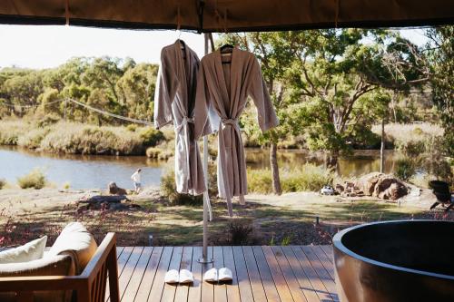a robe hanging from an umbrella on a deck at Serenità Stanthorpe in Severnlea