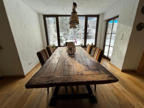 a dining room table with chairs and a vase on it at St. Anton in Grainau