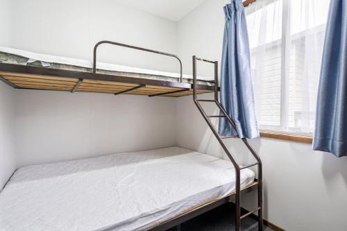 a bunk bed in a room with a window at Teralba Lakeside Caravan Park in Teralba