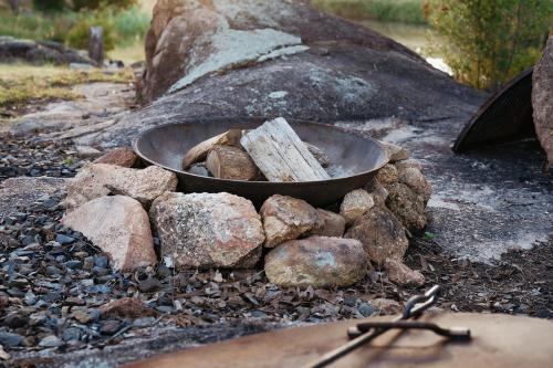 a bowl of wood sitting on a pile of rocks at Serenità Stanthorpe in Severnlea
