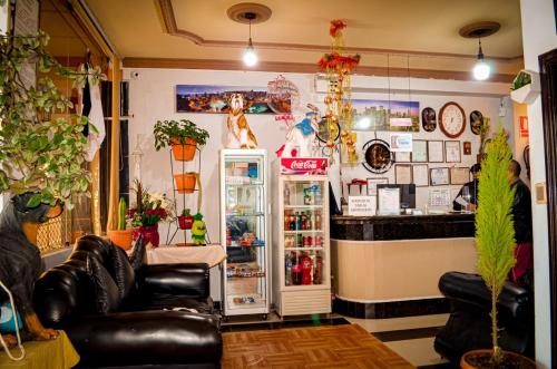 a room with a refrigerator and leather chairs at Hotel Lizarraga in La Paz