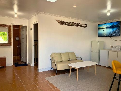 a living room with a couch and a table at YAJASU STAY Saipan in Saipan