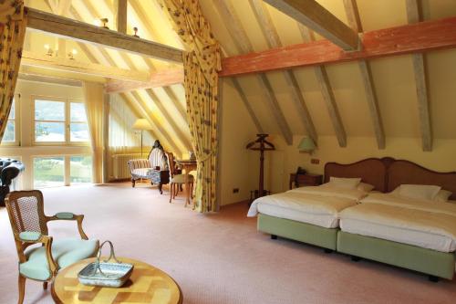 a bedroom with a bed and a table in a room at Landhotel der Schafhof Amorbach in Amorbach