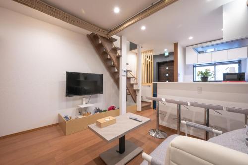 a living room with a couch and a tv at 和居 東桜 静かで落ち着く 大阪城近くの好立地物件 in Osaka