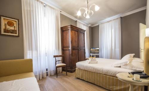 A Palazzo Busdraghi Residenza D'Epoca tesisinde bir odada yatak veya yataklar