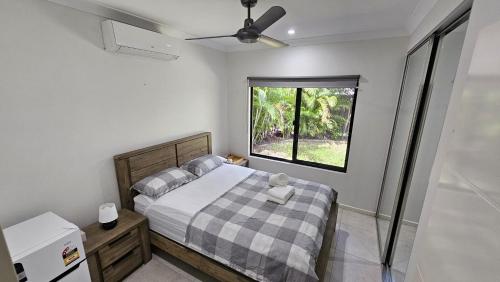 a small bedroom with a bed and a window at Private Room in Palmerston in Palmerston