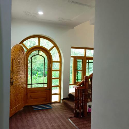an entrance to a room with a wooden door at The Himalayan Inn homestay in Gulmarg