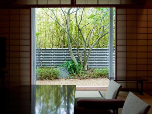 a window in a room with a tree outside at The Prince Park Tower Tokyo - Preferred Hotels & Resorts, LVX Collection in Tokyo