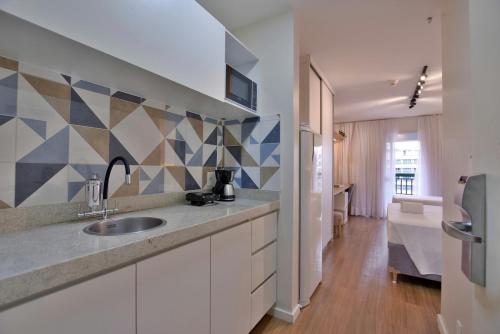 a kitchen with a sink and a counter top at BSB Stay Flats Particulares - SHN in Brasília