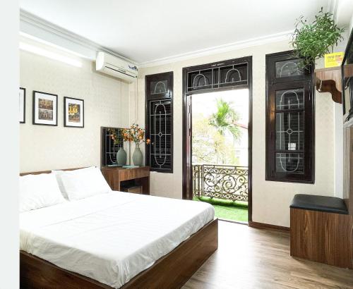 a bedroom with a white bed and a window at Hanoi Oriental Viewl Hotel in Hanoi