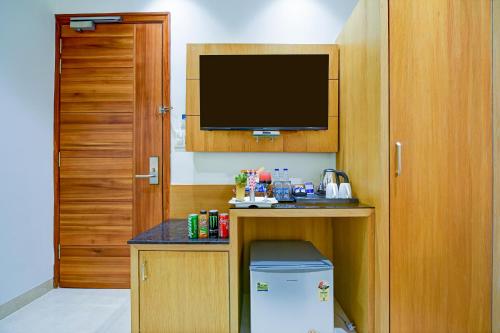 a room with a television and a small refrigerator at Classio Royale By iO Hotels Near Golden Temple in Amritsar