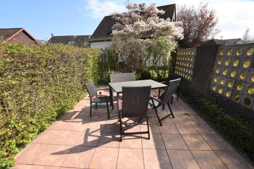 a table and chairs sitting on a patio at Reihenendhaus Marina Sol in Dahme