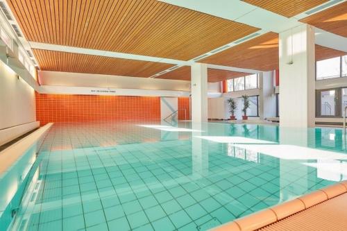 a swimming pool with a glass floor in a building at FeWo Ferienglück Berolina 131 in Dahme