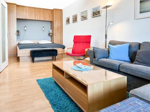 a living room with a couch and a bed at FeWo Ferienglück Berolina 131 in Dahme