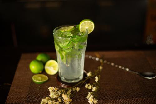 a drink with a lime on a table at Pakse hotel & Restaurant in Pakse