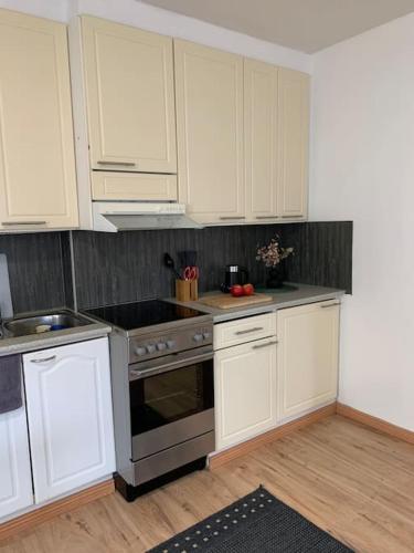 a kitchen with white cabinets and a stove top oven at 2BR big Apartment A8, free parking on the street in Oulu