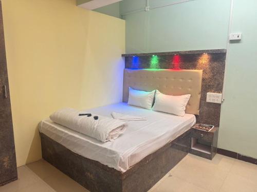 a bedroom with a bed with white sheets and pillows at Relax Zone in Patna