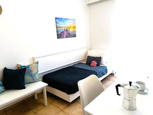 a small room with a bed and a table at Nautilus City Studios & Apartments in Rhodes Town