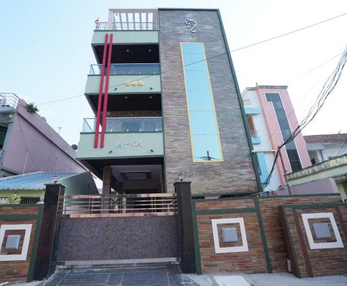 a tall brick building with a clock tower at Katyayani Serenity - Your Premium Homestay in Bhadrāchalam