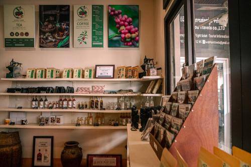 a store with a shelf of products on the wall at Pakse hotel & Restaurant in Pakse