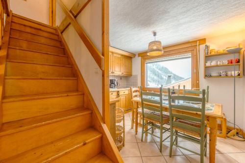 a kitchen with a staircase and a table and chairs at 3 chambres - Plan des Reines - 356 - Happy Rentals in Chamonix-Mont-Blanc